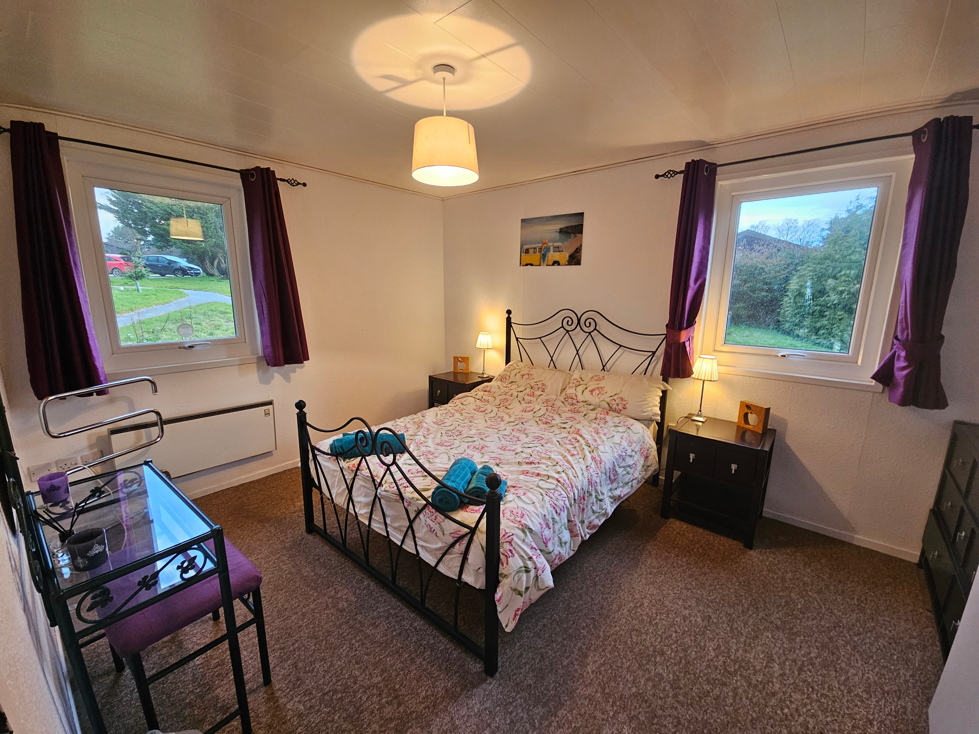 The main bedroom which has a double bed, vanity, dresser and wardrobe